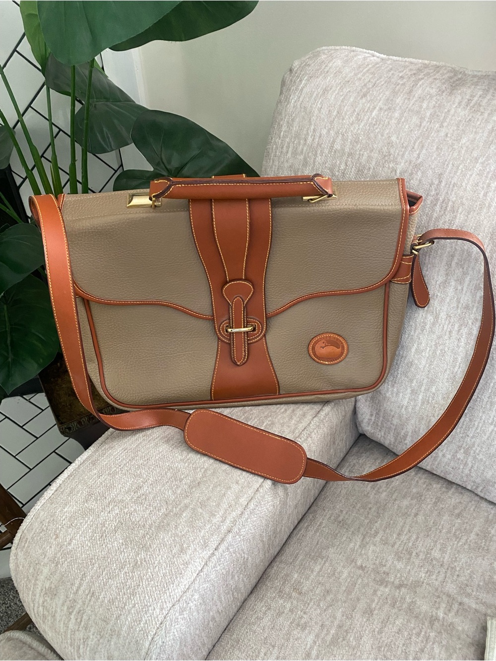 vintage Dooney & Bourke All Weather Leather tan messenger bag.